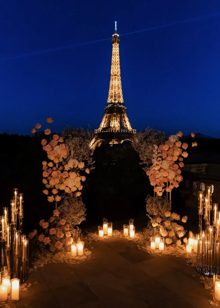 Paris proposal setup on a private Shangri-La Paris terrace with Eiffel Tower view at blue hour, featuring blush florals and candlelit pathway