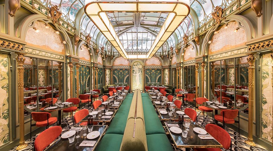 Beef Bar Paris restaurant stunning Art Nouveau glass ceiling dining room with red velvet chairs and gilded decor