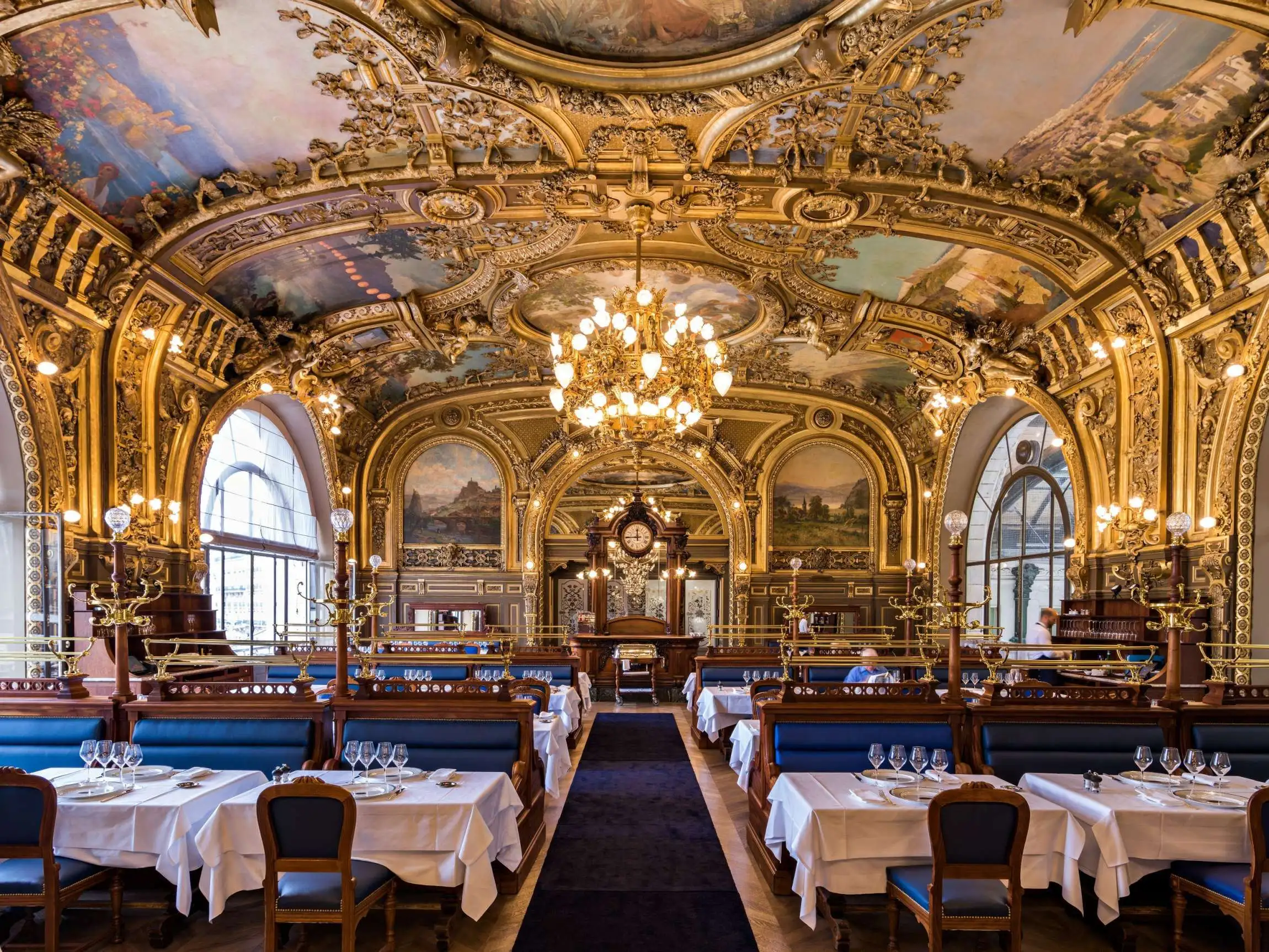 Le Train Bleu Paris restaurant magnificent Belle Époque dining room with gilded ceiling paintings, blue velvet banquettes and bronze chandeliers at Gare de Lyon