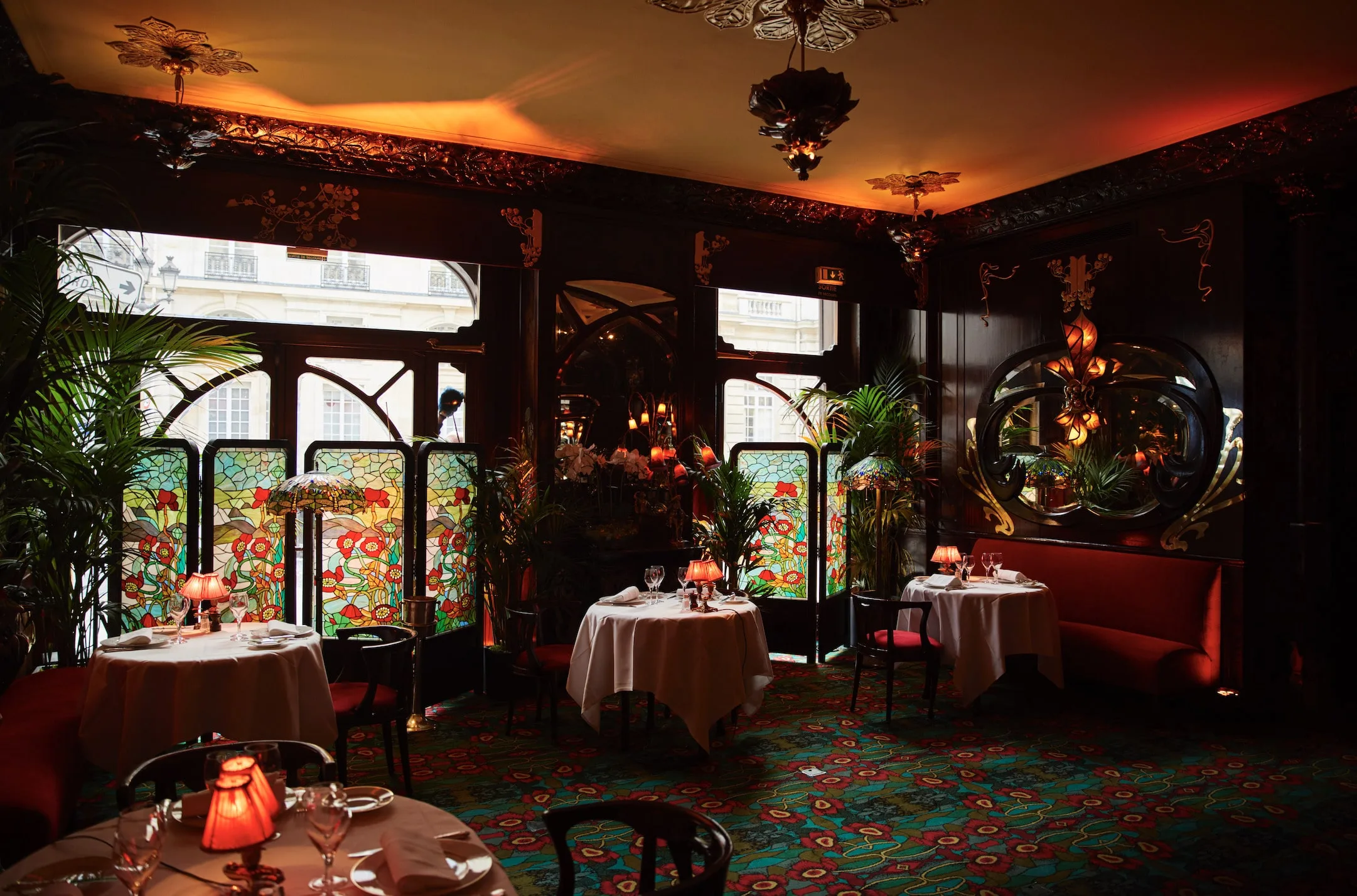 Maxim's Paris iconic Art Nouveau dining room with stained glass panels and Belle Époque decor