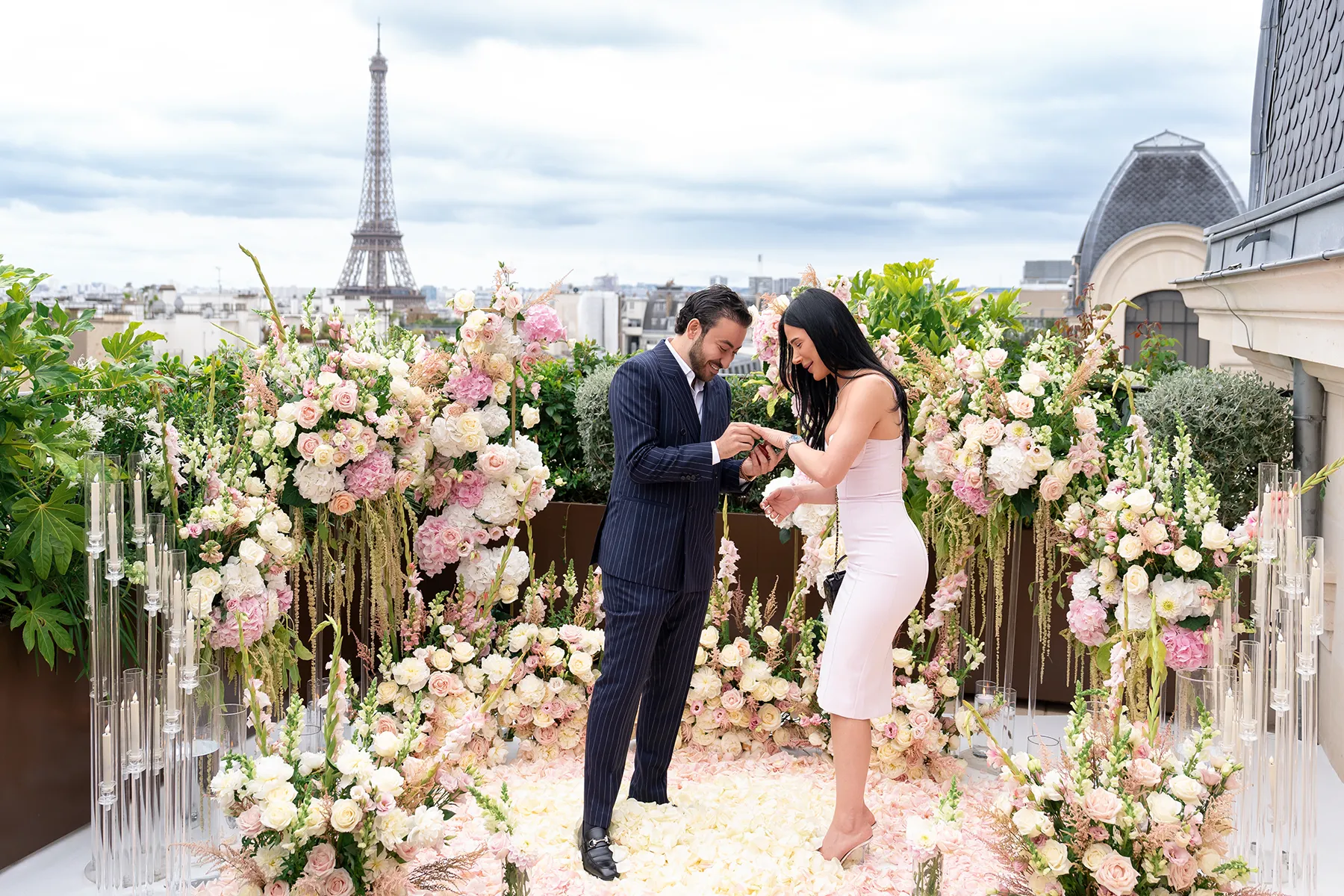 Rooftop proposal at The Peninsula Paris with ring exchange, floral aisle, candlelight, and Eiffel Tower view