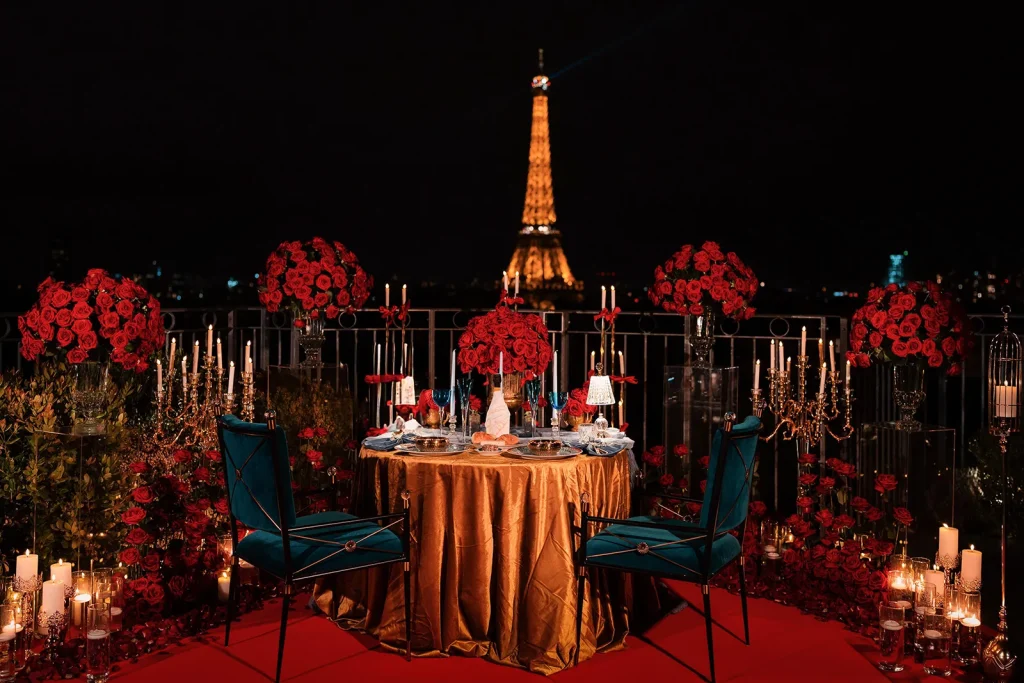 Private rooftop proposal dinner table set with red roses and Eiffel Tower view