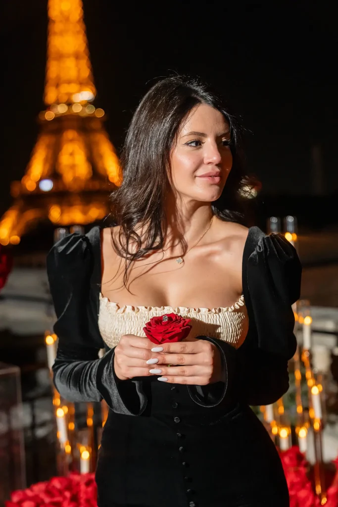 Woman holding a red rose with her engagement ring visible on The Shangri-La Paris rooftop