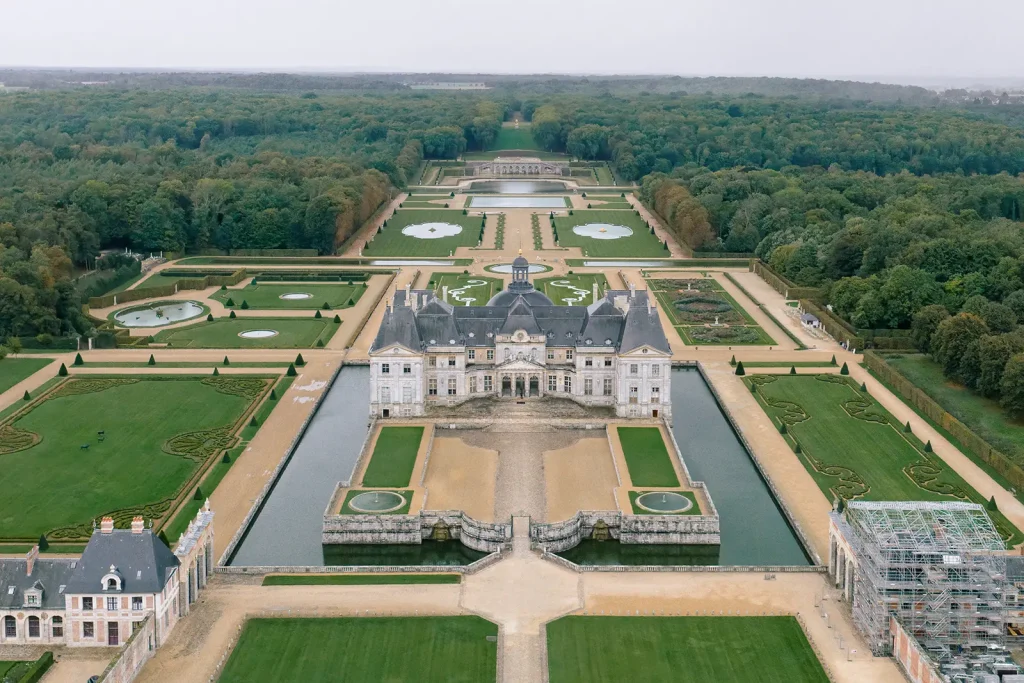 Aerial view of Château de Vaux-le-Vicomte with symmetrical gardens and moat