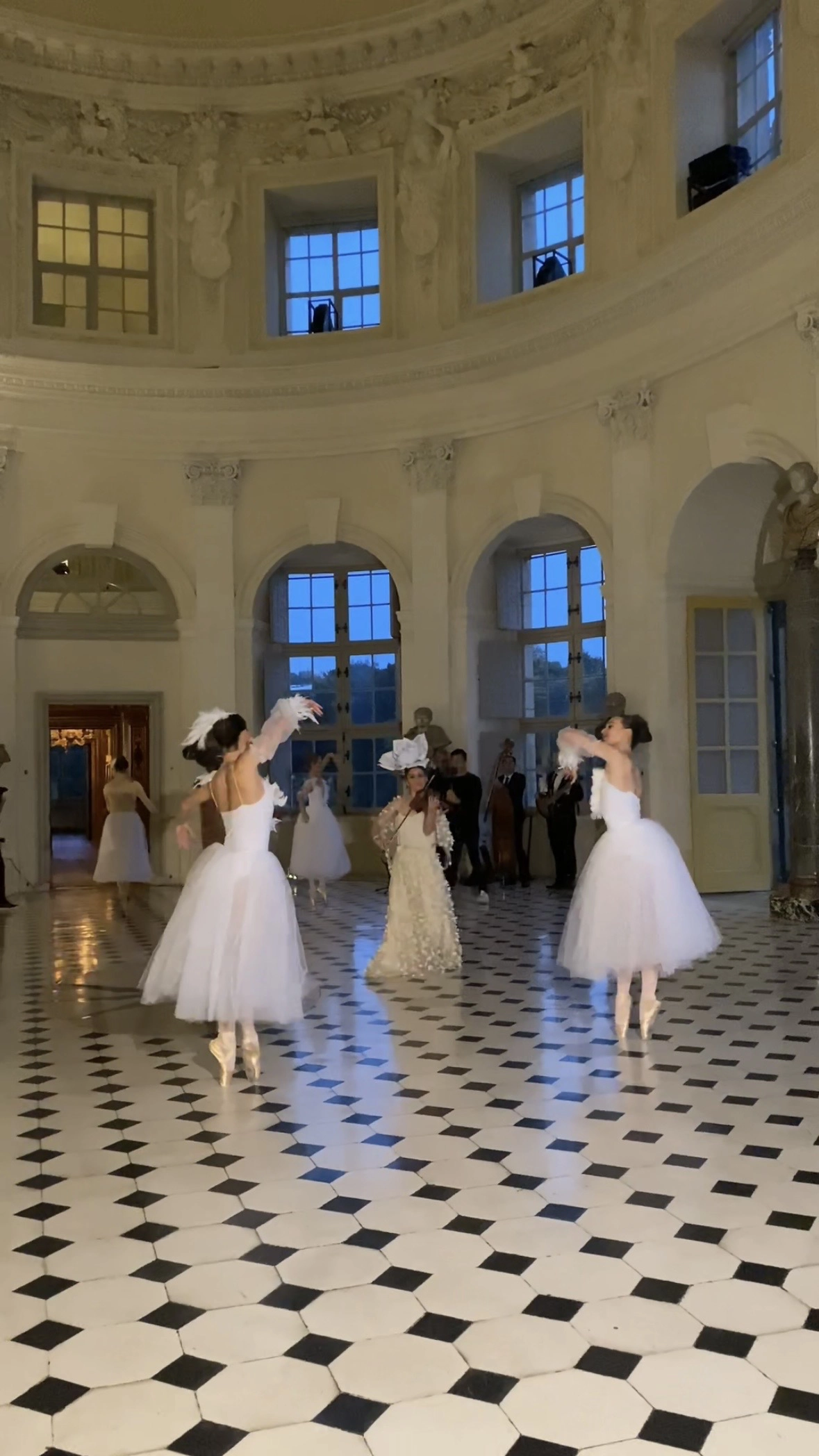 Ballerinas dance in domed rotunda at Château de Vaux-le-Vicomte with live violinist