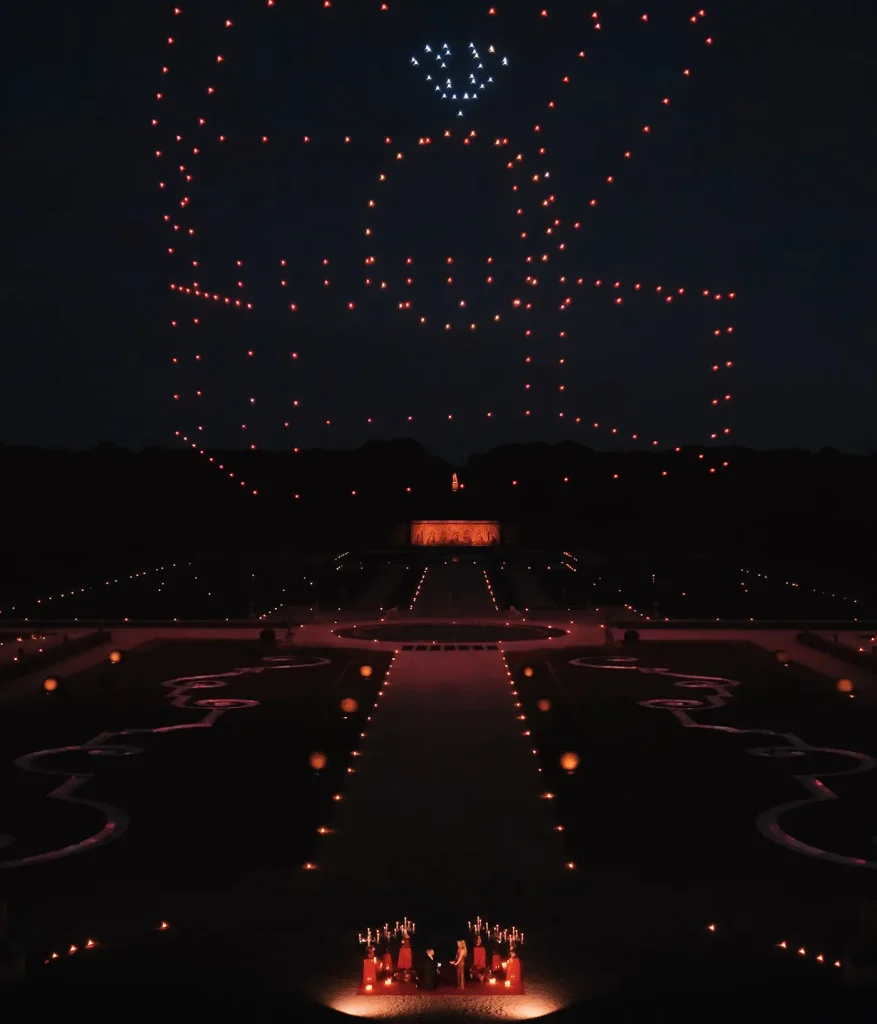 Drone show forming an engagement ring box above Château de Vaux-le-Vicomte during a private proposal.
