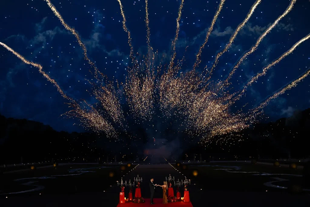 Fireworks exploding above Château de Vaux-le-Vicomte after a private marriage proposal in the gardens.