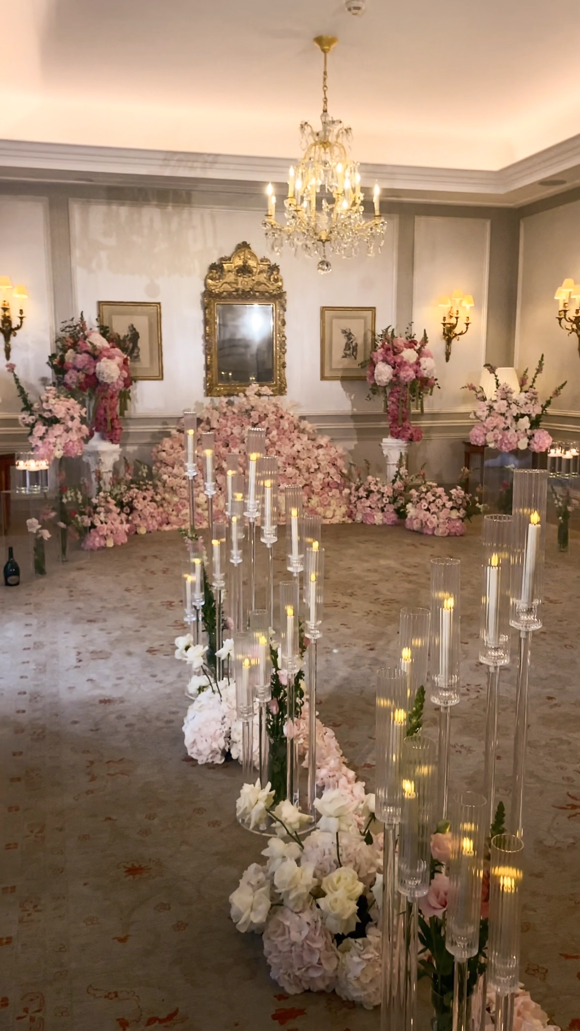 Pink rose floral installation and candlelit aisle in proposal room at Le Bristol Paris