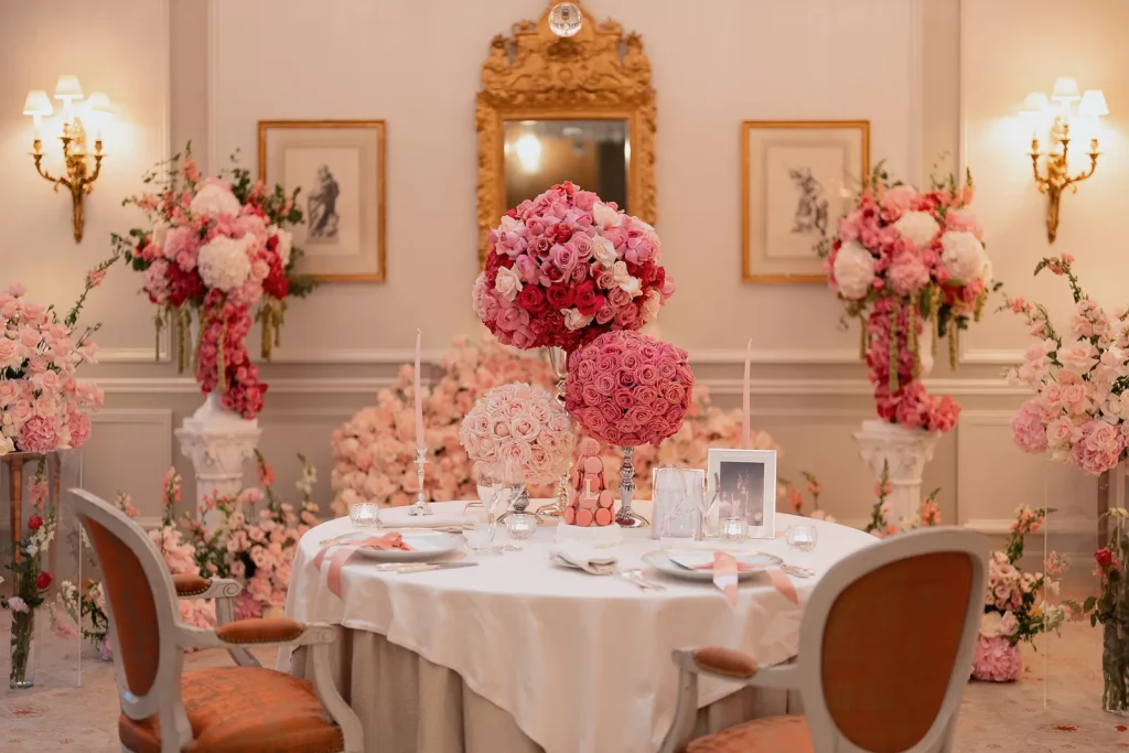 Private dinner table surrounded by floral arrangements inside the Rambouillet Salon at Le Bristol Paris after the proposal.