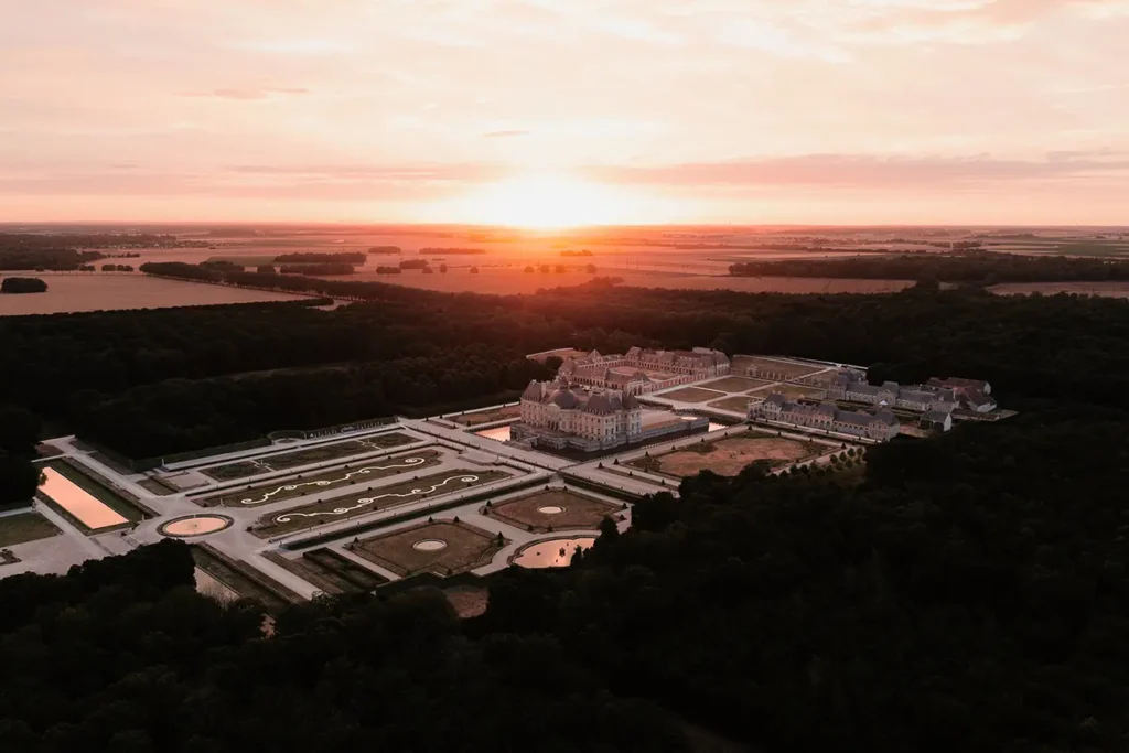 Aerial view of Château de Vaux le Vicomte at sunset near Paris, formal gardens and chateau grounds