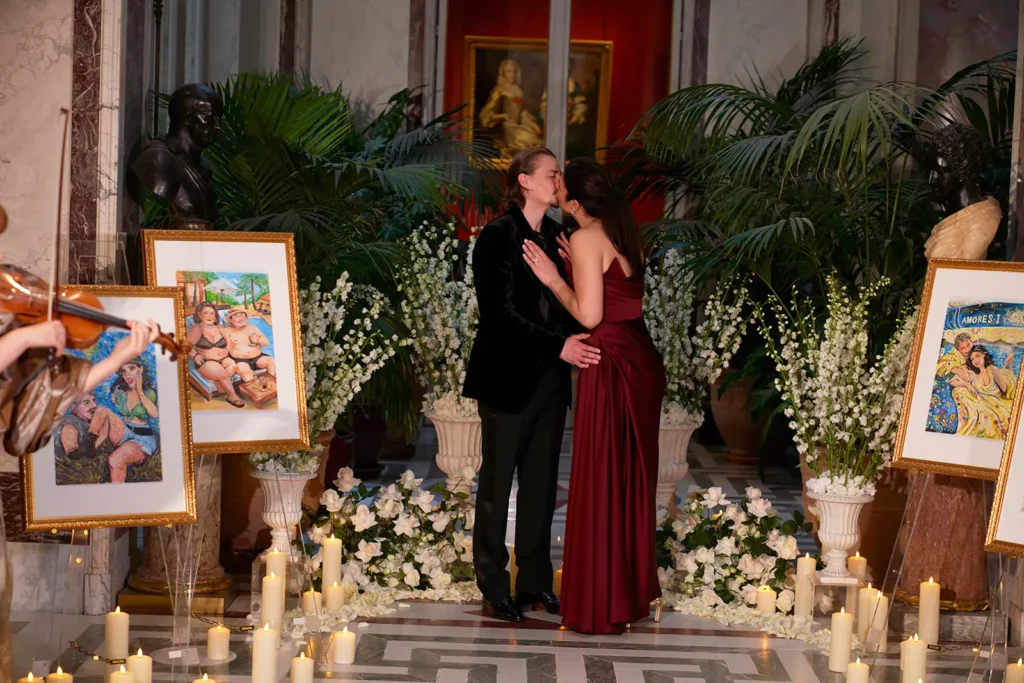 Proposal kiss at Musée Jacquemart André Paris, couple embracing among candles and flowers with the ring visible