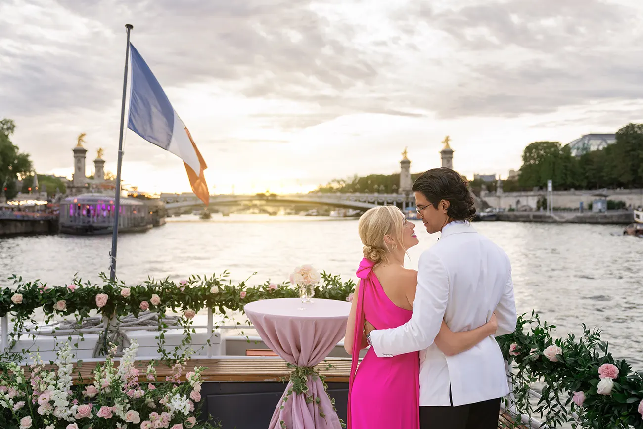 Couple on a private Seine yacht proposal in Paris with Eiffel Tower in the background