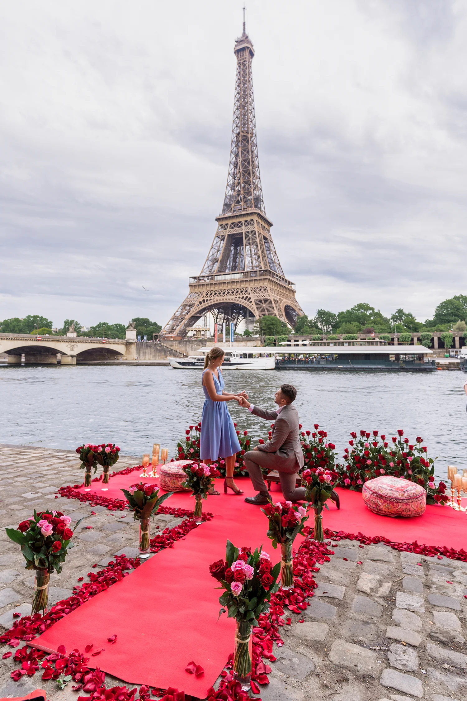 Public Eiffel Tower proposal setup on the Seine with floral décor and the Eiffel Tower in the background